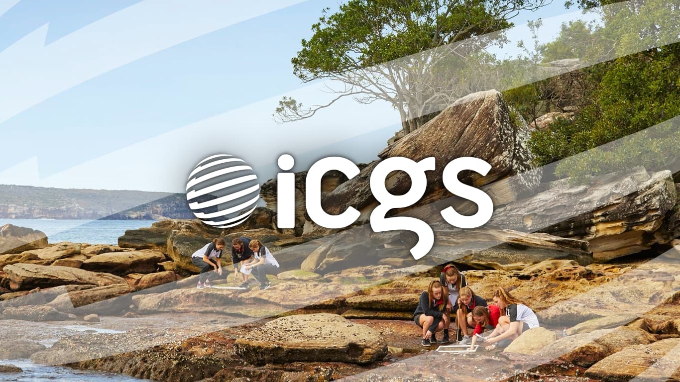 The International Coalition of Girls Schools logo super-imposed over a photo of the shoreline of Sydney Harbour, near Queenwood School at Balmoral Beach